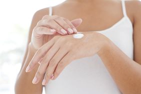 Woman applying hand cream